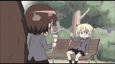 a girl is sitting on a bench while another girl is holding an ice cream cone ..
