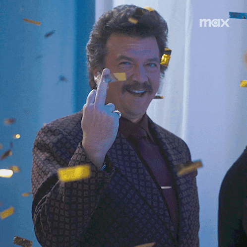 a man in a suit and tie is giving the middle finger in front of a max sign