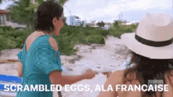 two women on a beach with the words scrambled eggs ala francaise on the bottom