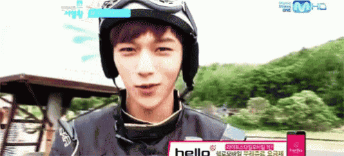 a young man wearing a helmet and goggles is talking to someone on a tv show .