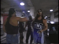 a man wearing sunglasses and a tank top that says nwo