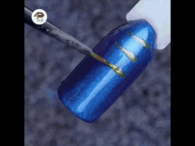 a bottle of nail polish is being used to paint a blue nail