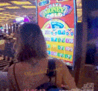 a woman is playing a slot machine that says crazy money gold