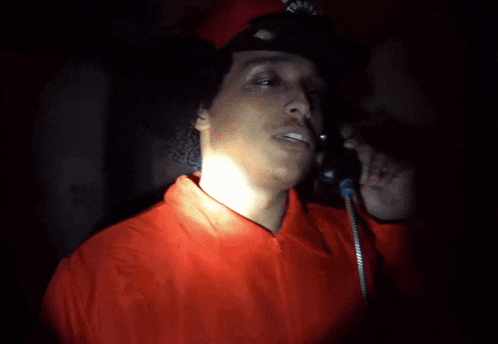 a man wearing a red jacket and a hat with a skull on it