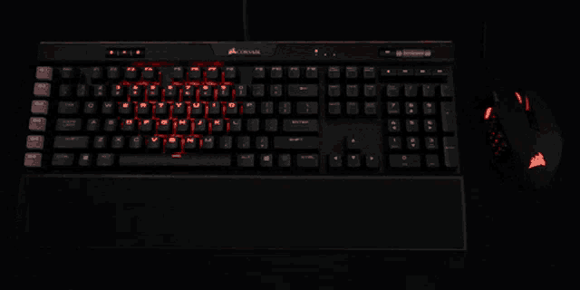 a corsair keyboard is lit up in red