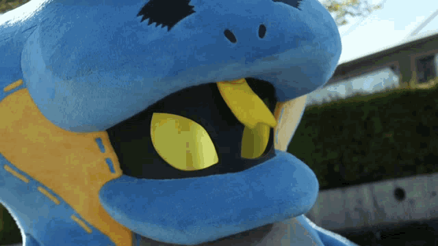 a close up of a blue and yellow stuffed animal