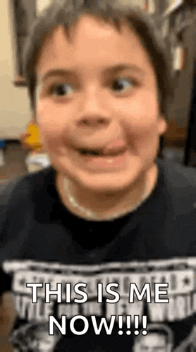 a young boy is sticking his tongue out and making a face .