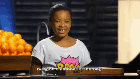 a young girl says i 've got this one in the bag while sitting at a table