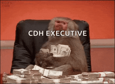 a monkey is sitting in a chair holding a pile of money and a stack of bills .