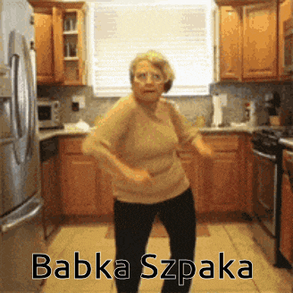 a woman is dancing in a kitchen with the words babka szpaka on the bottom right