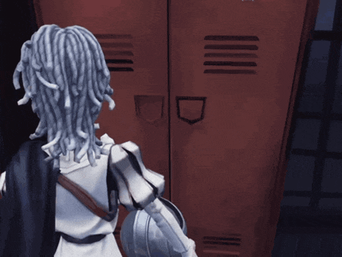 a person with dreadlocks is standing in front of a red locker