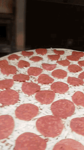 a pepperoni pizza with cheese and pepperoni slices on top