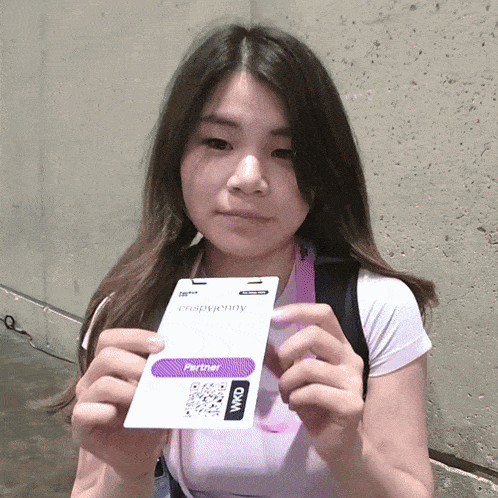 a woman is holding a crispypenny badge