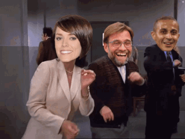 a woman in a suit is dancing with two men