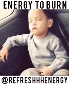a young boy is sitting in the back seat of a car .
