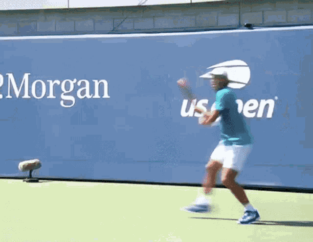 a man playing tennis in front of a morgan ad