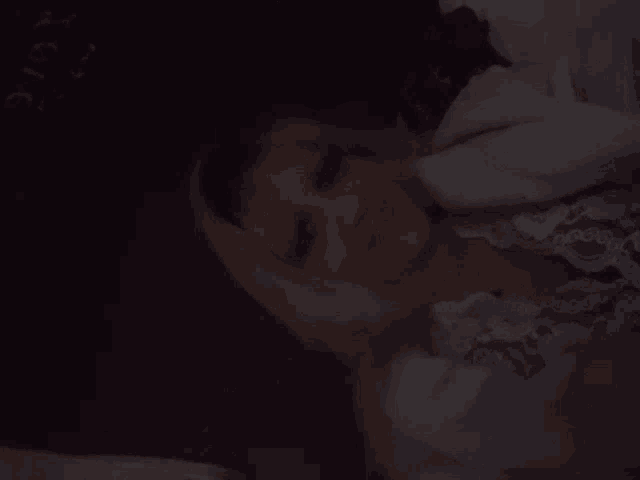 a woman laying on a bed with the word magic written on the wall in the background