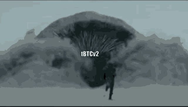 a man is running in front of a large worm in the sand .