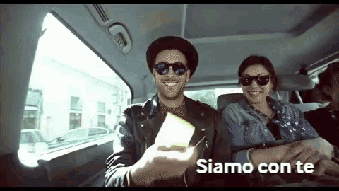 a man and a woman in a car with the words siamo con te