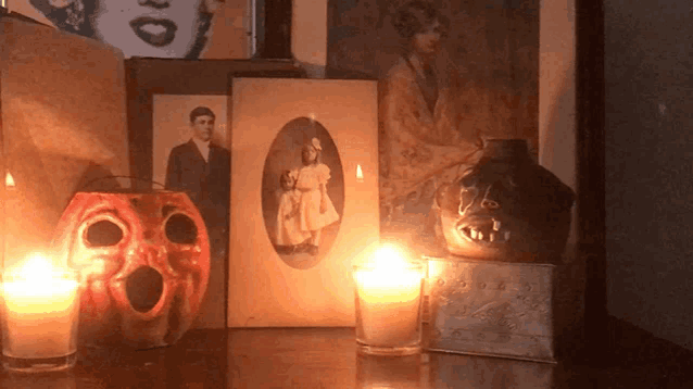 candles are lit up in front of a picture of a man and woman