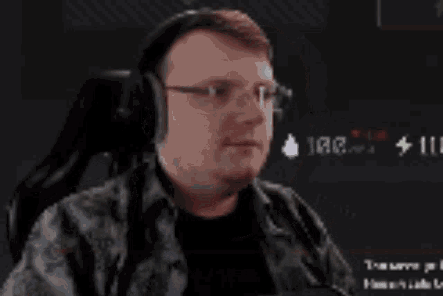 a man wearing headphones is sitting in a chair with his mouth open