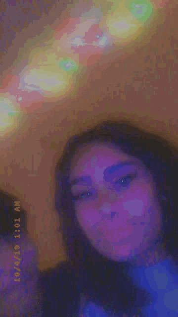 a girl is taking a picture of herself with a rainbow in the background and a time stamp of 11:01 am