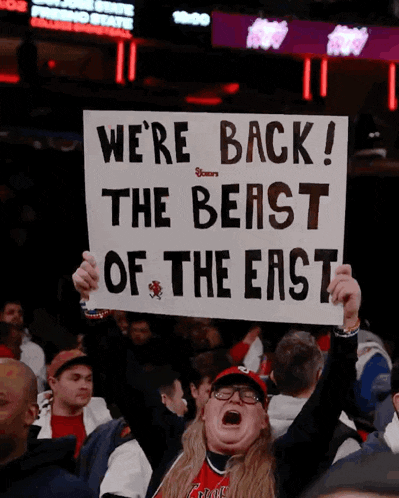 a fan holds up a sign that says we 're back