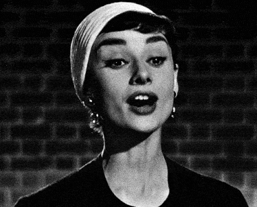 a black and white photo of a woman singing