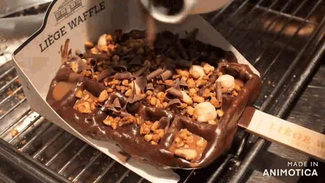 a liege waffle with chocolate and nuts is being made