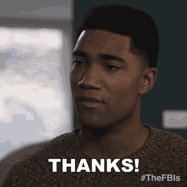 a man in a brown sweater says thanks on his face