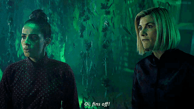 two women are standing next to each other and one of them is saying " fins off "