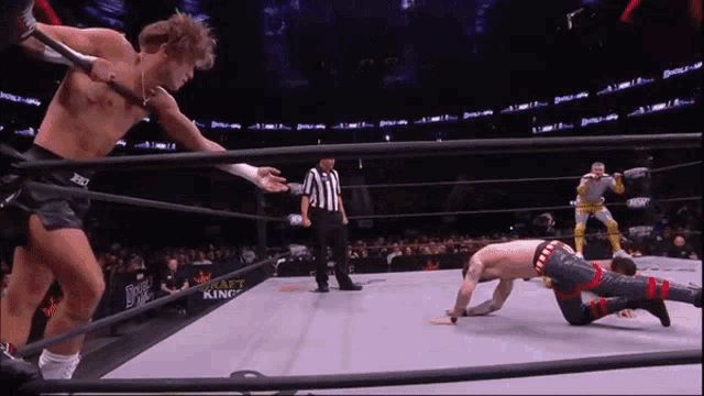 a wrestler in a ring with the word draft king on the back of his shorts