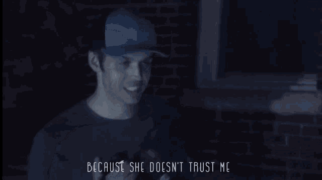 a man holding a gun with the words because she does n't trust me below him