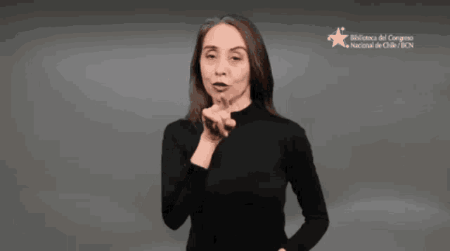 a woman in a black shirt is making a funny face