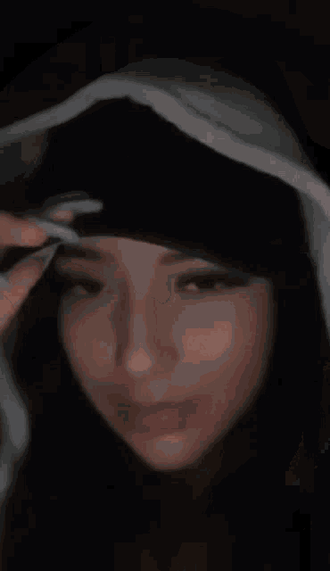 a woman is smoking a cigarette in a blurry photo .