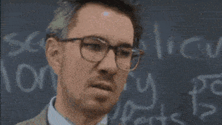 a person sitting at a desk with a pencil in their hand and the word aul on the bottom right
