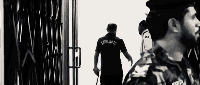 a black and white photo of a man in a military uniform that says snrjm id on the back