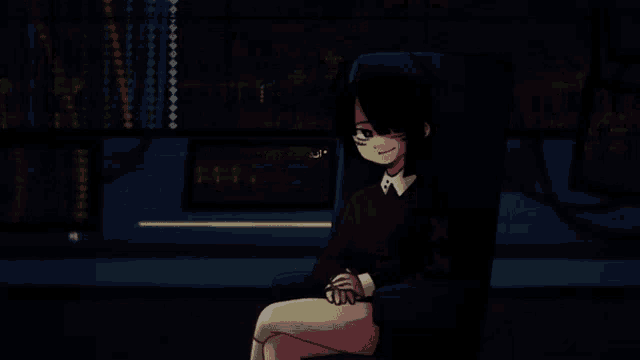 a girl is sitting in front of a computer screen that says " a "