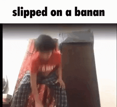 a boy is sitting on a banana while wearing a red shirt and pants .