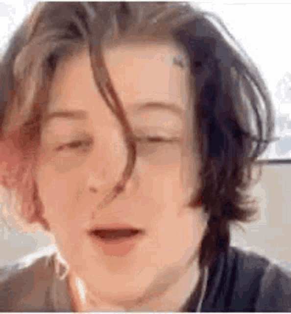 a close up of a person 's face with their eyes closed .