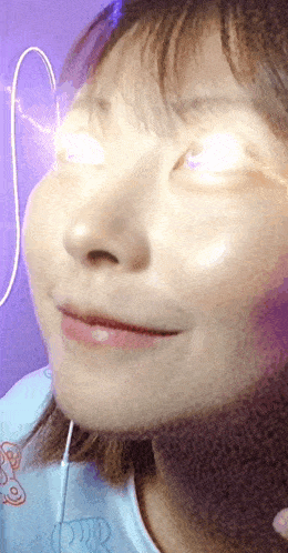 a close up of a woman 's face with her eyes glowing