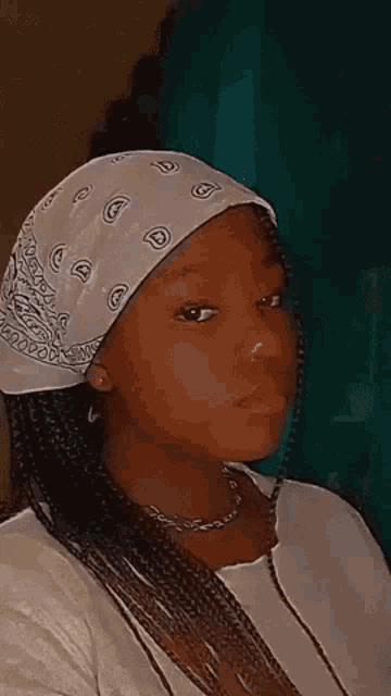 a woman wearing a bandana and a nose ring .
