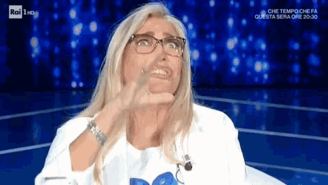 a woman wearing glasses is making a face on rai 1 hd