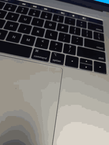 a close up of a laptop keyboard with the command option key highlighted