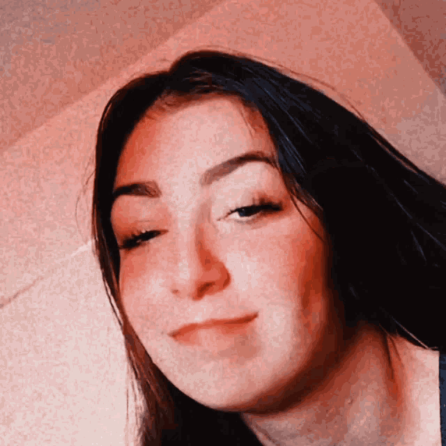a close up of a woman 's face with a blurred background
