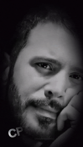 a close up of a man 's face with the letters cp on the bottom right