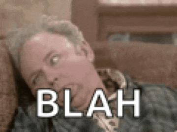a man is laying on a couch and making a funny face with the word blah on his face .