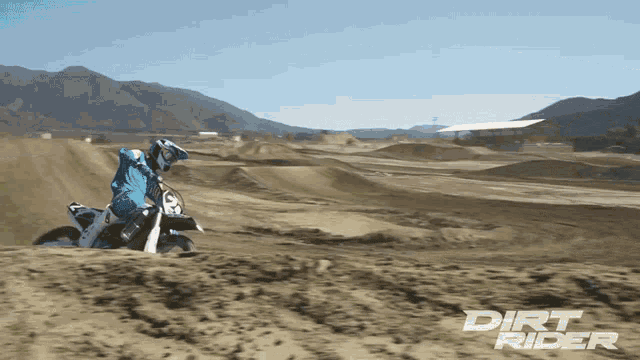 a dirt rider rides a dirt bike on a dirt track