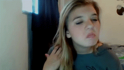 a woman with long blonde hair is making a funny face with her hand on her shoulder