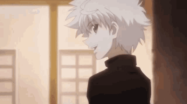 a close up of a person with white hair standing in front of a window in a room .